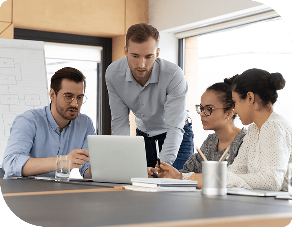 four workers in meeting looking at laptop